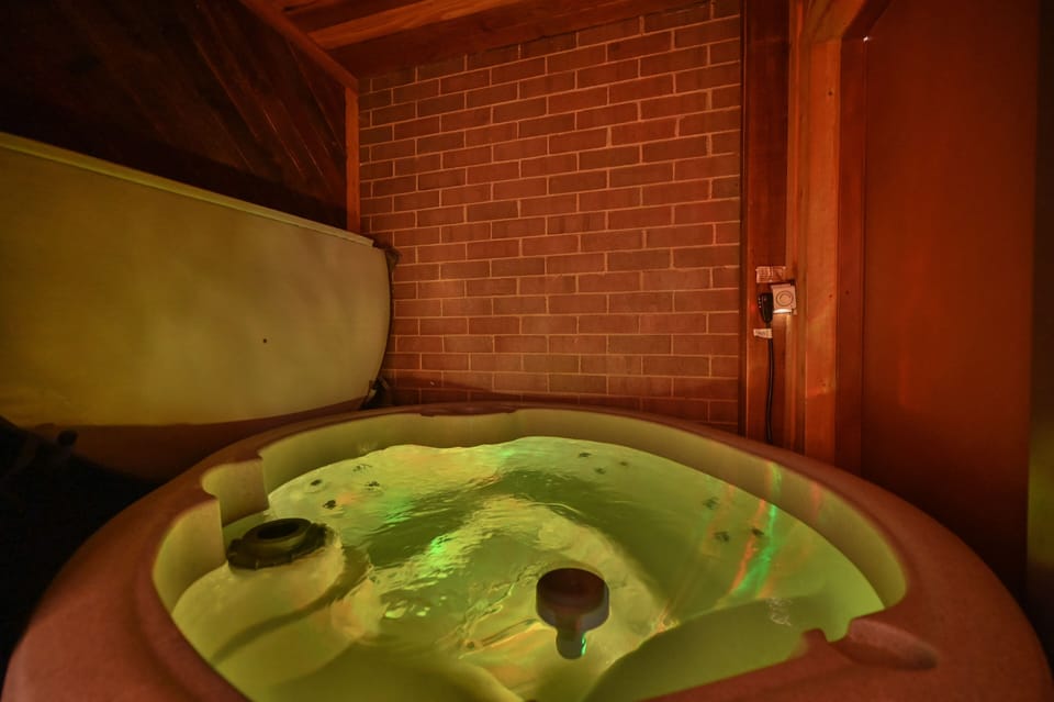 Private Hot tub in Cedar and brick room. 