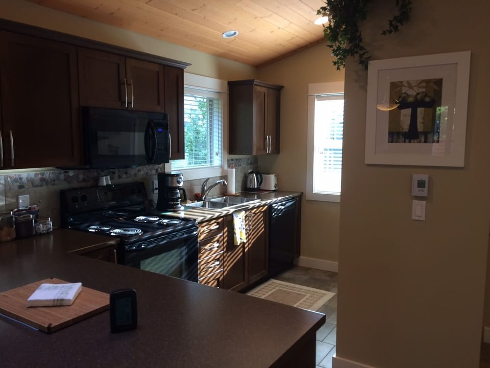 Bright kitchen with barstools at counter 