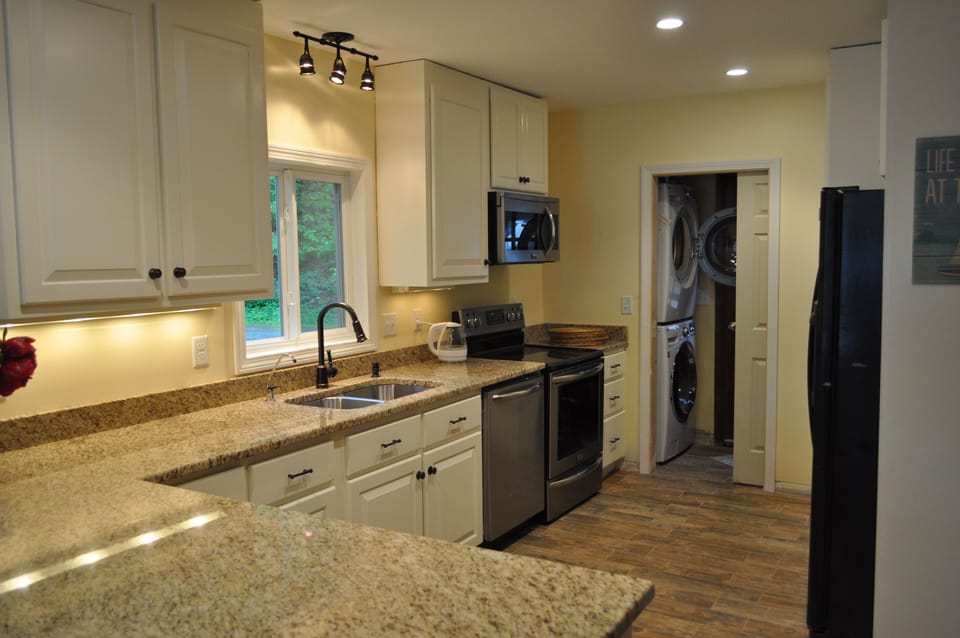 The kitchen has all new appliances, adjacent washer and dryer
