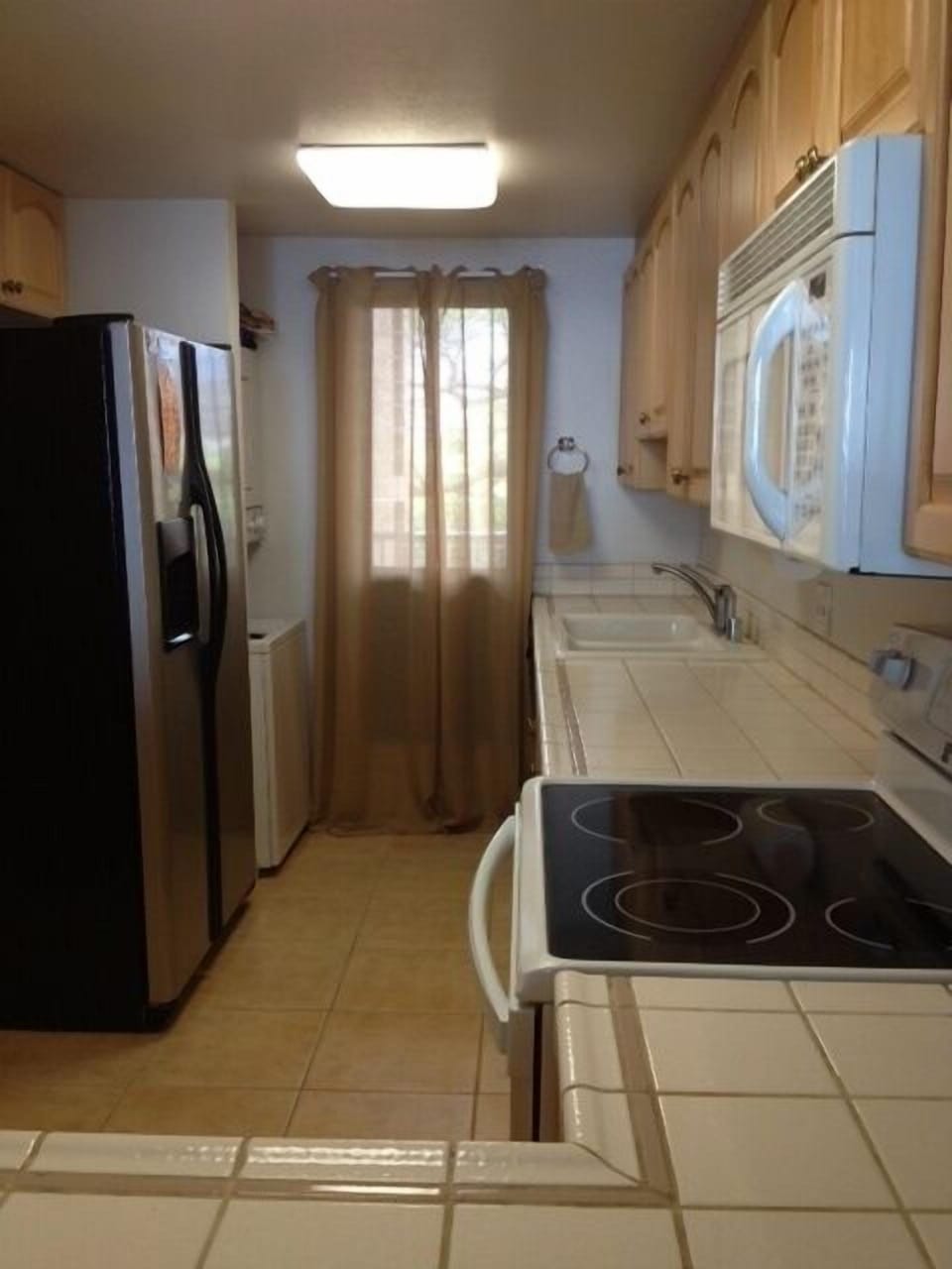 Full view of kitchen-washer/dryer to right of refrigerator
