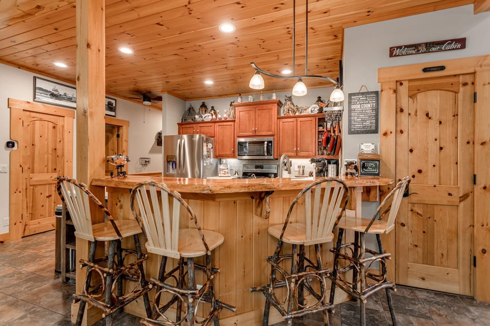 4 unique, handmade dining seats with swivel feature placed around bar top. 2022.