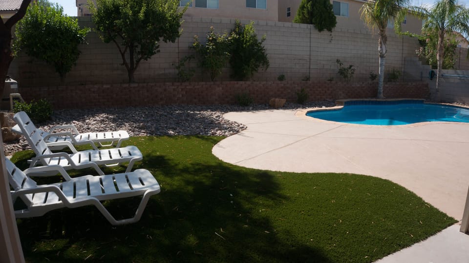 8 ft deep lagoon style pool, above ground hot tub, covered patio, BBQ