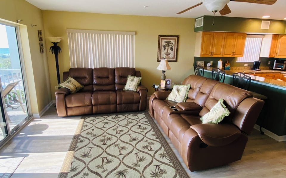 Living room with view into kitchen granite bar and bar stools