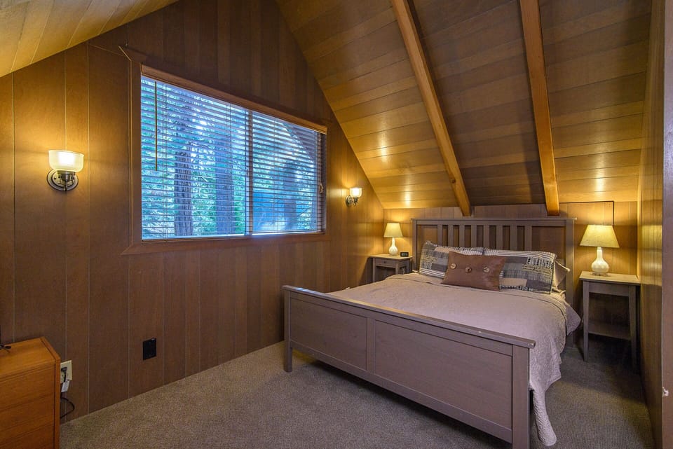 Upstairs bedroom #2 with a queen-size bed and baseboard heat.