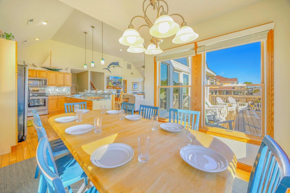 Gather around this spacious dining table where memorable meals await, with your fully-equipped kitchen nearby and deck access for seamless indoor-outdoor entertaining.