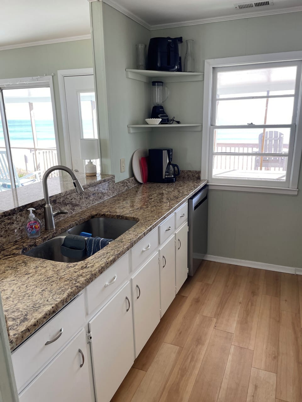 Kitchen granite countertops, coffee maker, microwave, stove and refrigerator