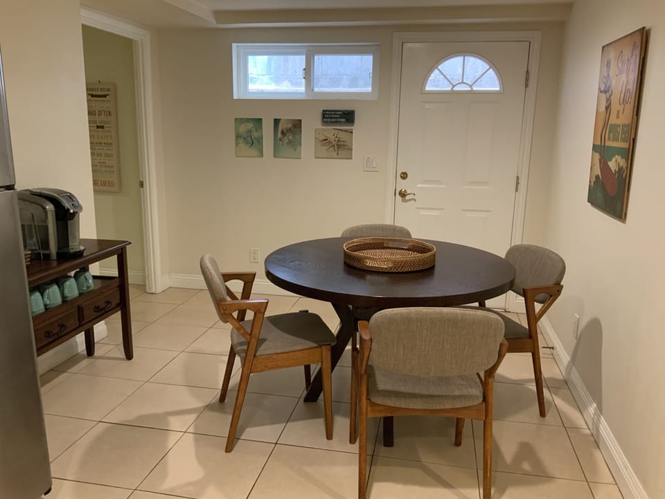 Dining room next to kitchen. Small breezeway is located outside with BBQ.