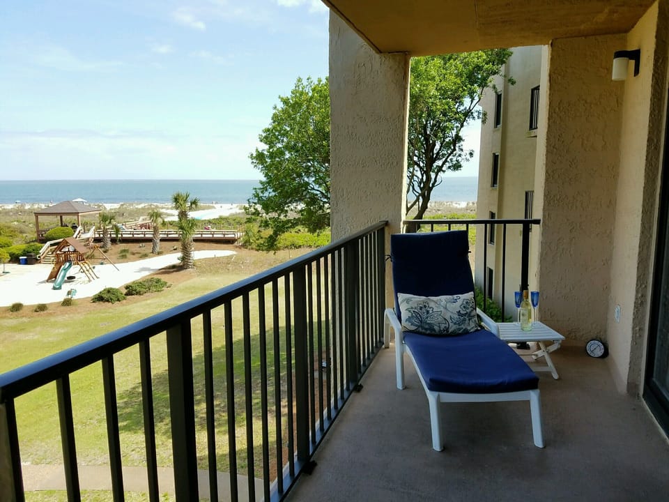 Ocean front view from balcony with chaise