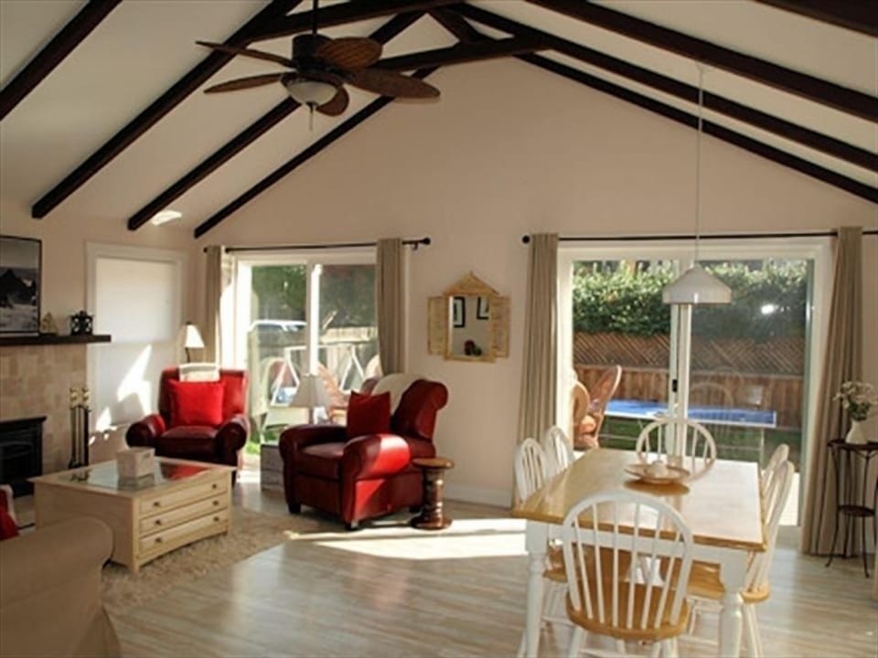 Living room opens to ping pong, french doors open to outside dining area