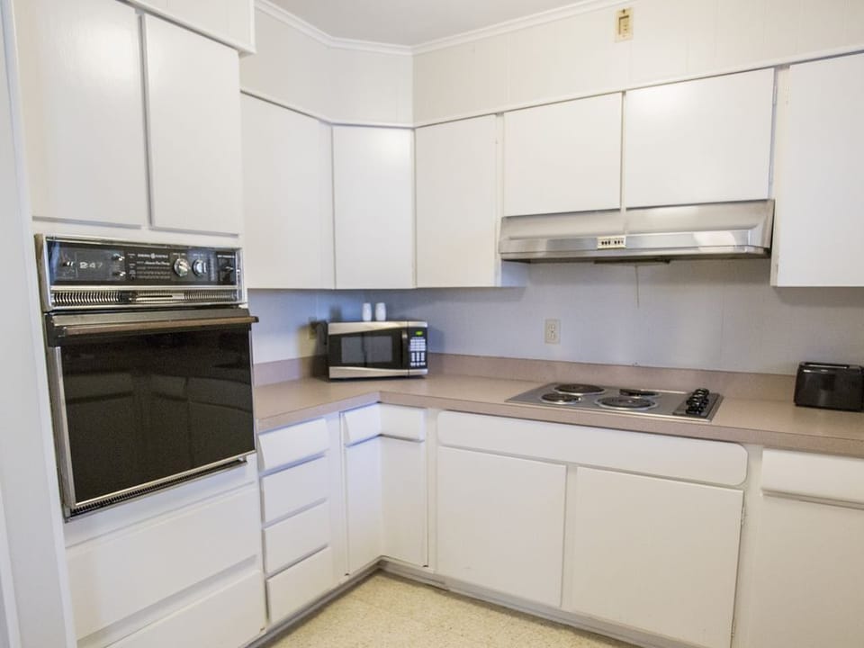 Kitchen area with stove, cook top, hood and microwave