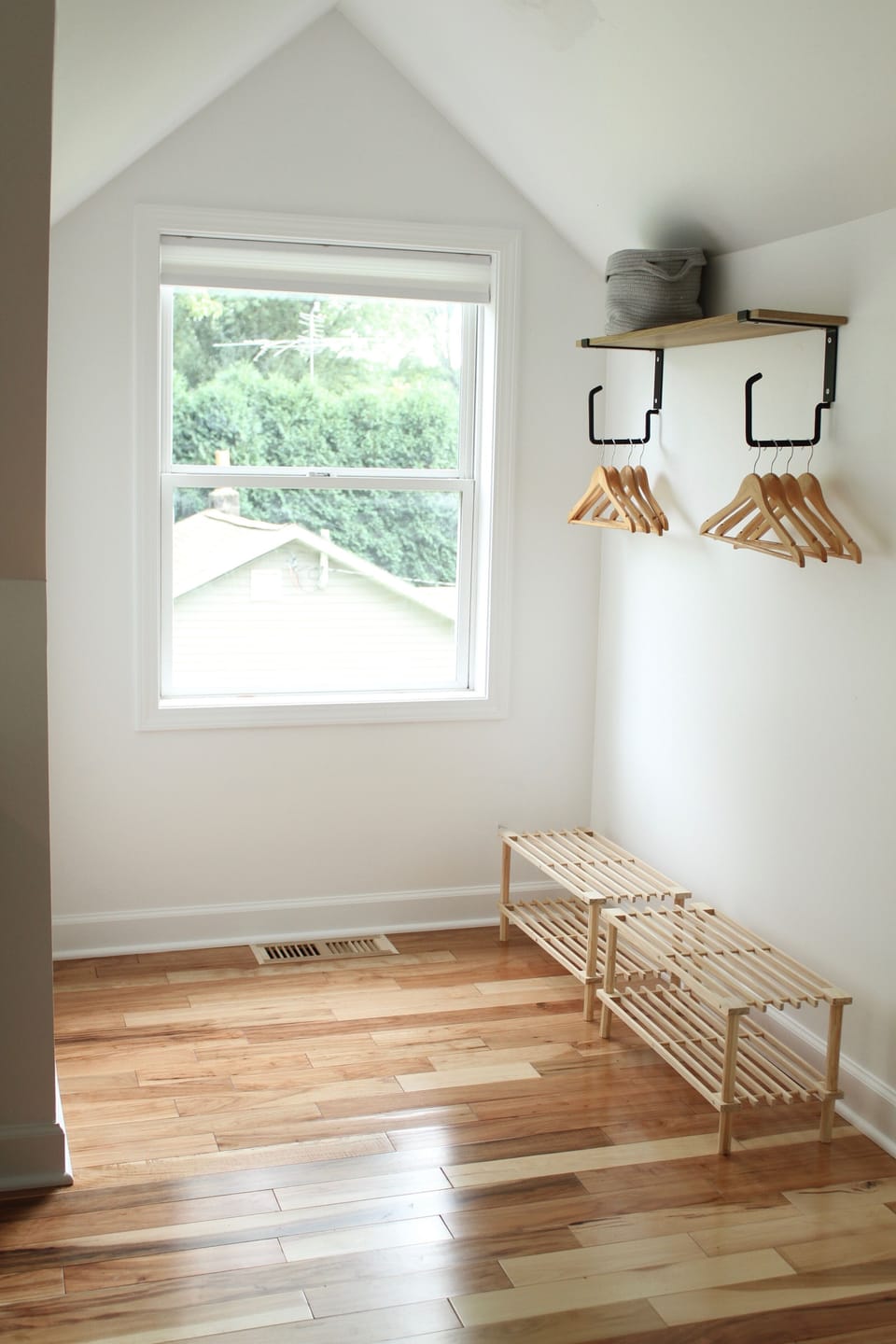 Both upstairs bedrooms feature built-in garment racks for easy storage