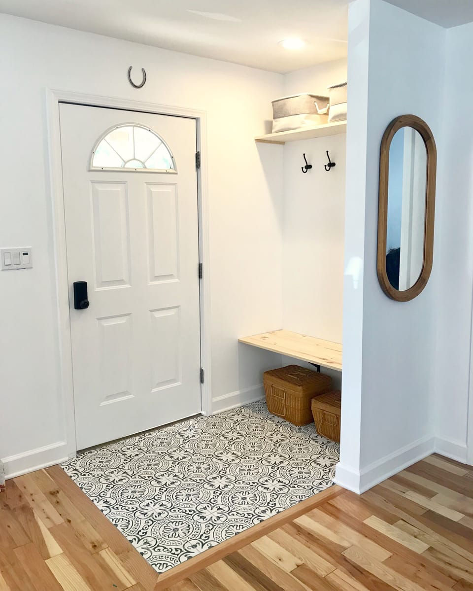 The foyer welcomes you with a spot to take off your shoes and drop your things