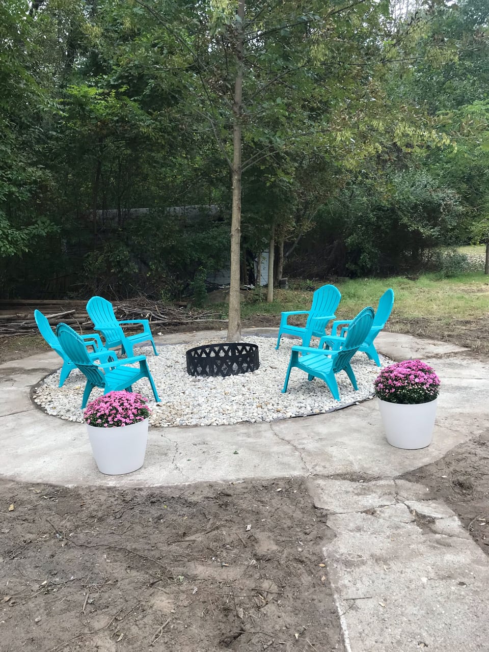 Backyard features a rear patio with dining area, fire pit & outdoor shower