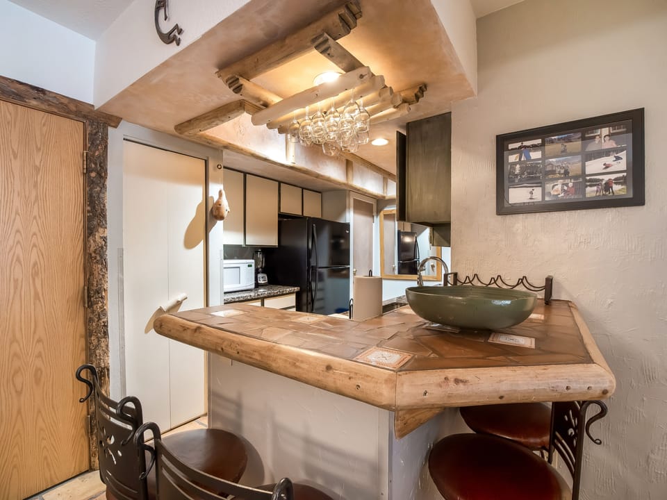 View of bar and kitchen.  Bar seats up to 4 people.