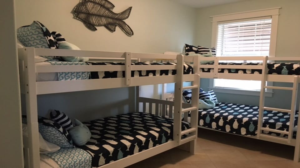 Bedroom with 2 sets of bunks and Xbox gaming system.