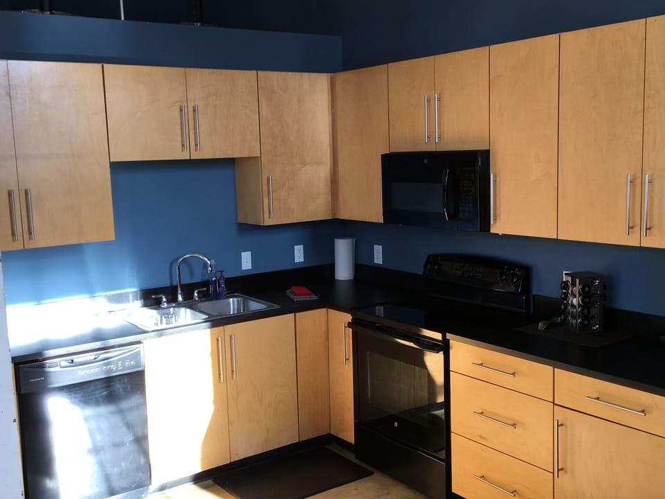 Kitchen is stocked for cooking & has several place settings