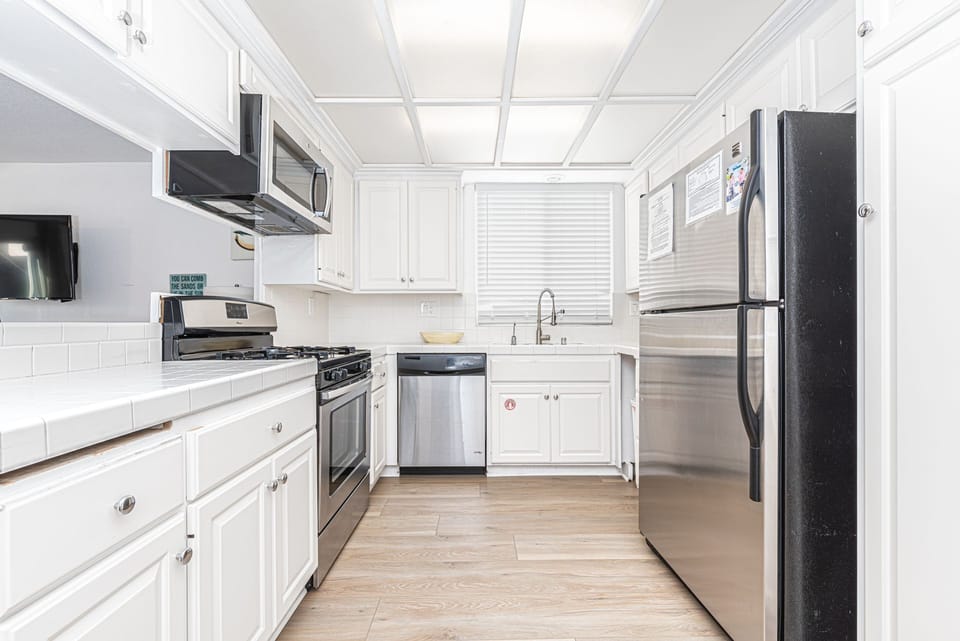 Kitchen is fully-stocked with dishes, cooking, baking and meal prep gear
                