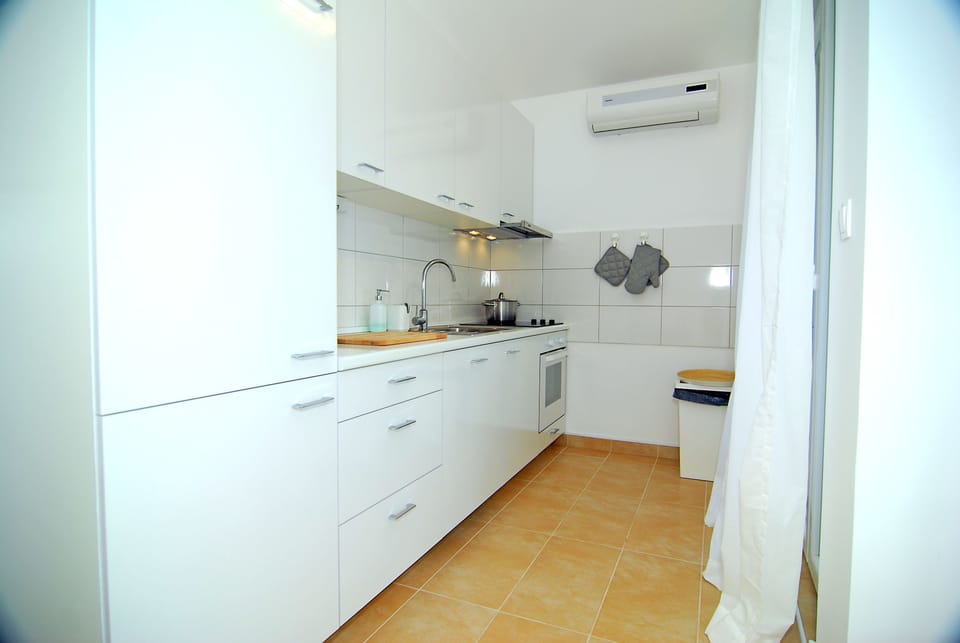 Apartment, Sea View | Private kitchen | Fridge, coffee/tea maker, electric kettle, cleaning supplies