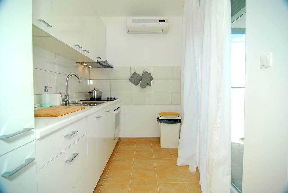 Apartment, Sea View | Private kitchen | Fridge, coffee/tea maker, electric kettle, cleaning supplies