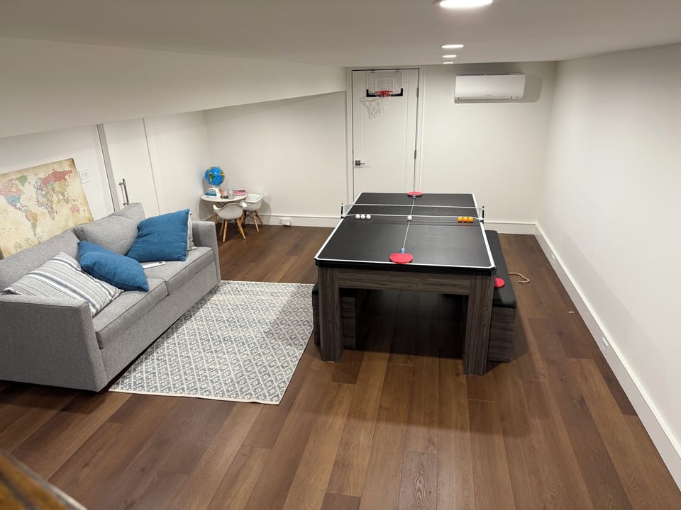 Recreation room with table that converts b/w ping pong, billiards, and craft tbl