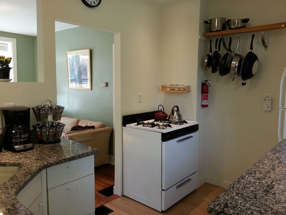Kitchen with granite counters, appliances, spices, pots/pans, dishes...