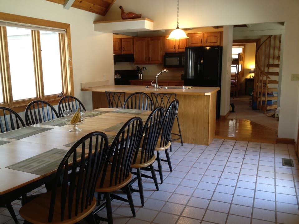 Dining area and kitchen. Seating for 10 at table and 2 at bar