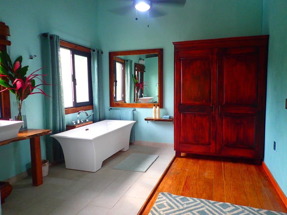 Master suite contains luxurious soaking tub and large dresser. 