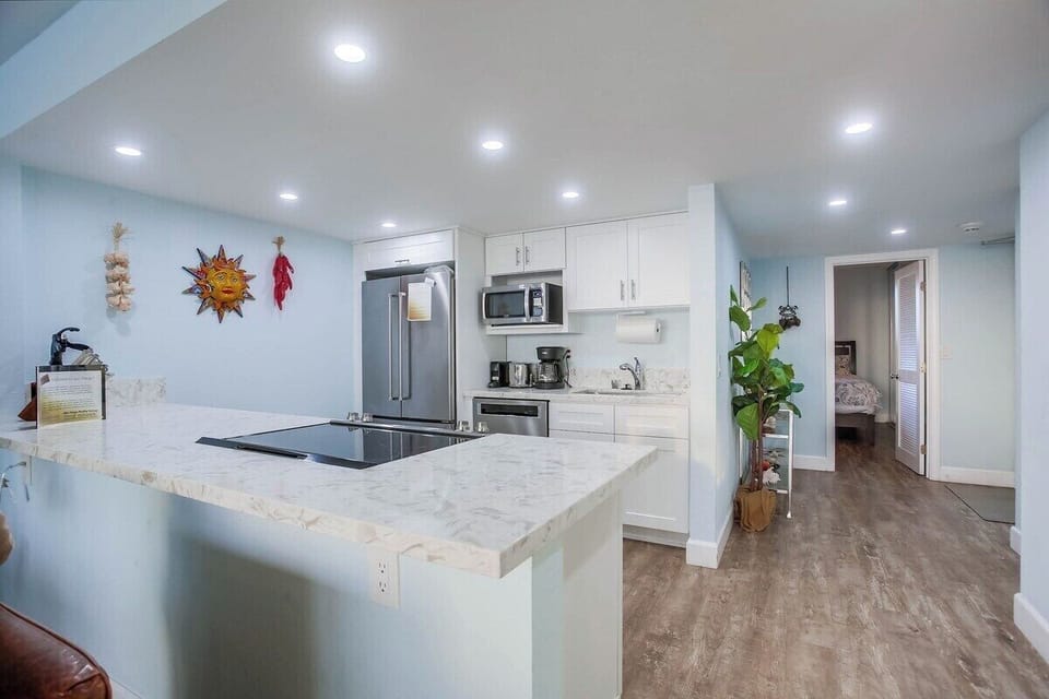 Fully equipped kitchen with stainless steel appliances and electric stovetop
