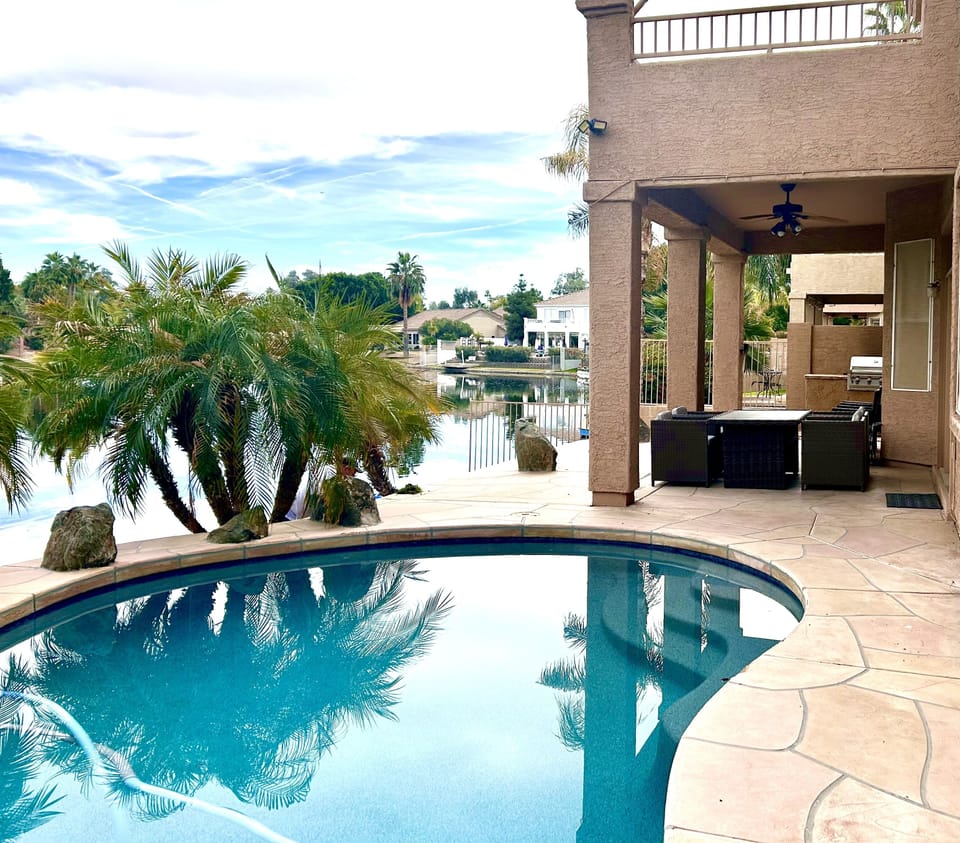 Pool and covered patio with deck above