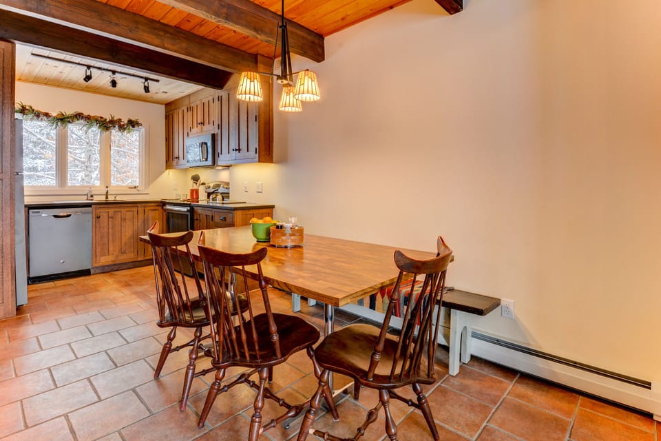 Eating area that seats six and kitchen beyond