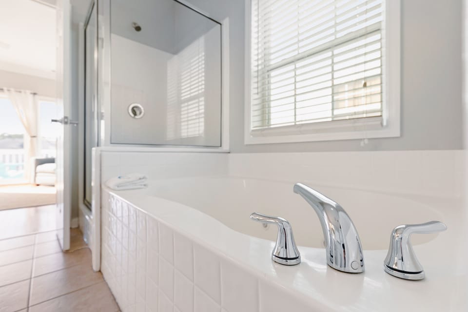 Relax and unwind in the large soaking tub, the perfect spot to enjoy a peaceful retreat.