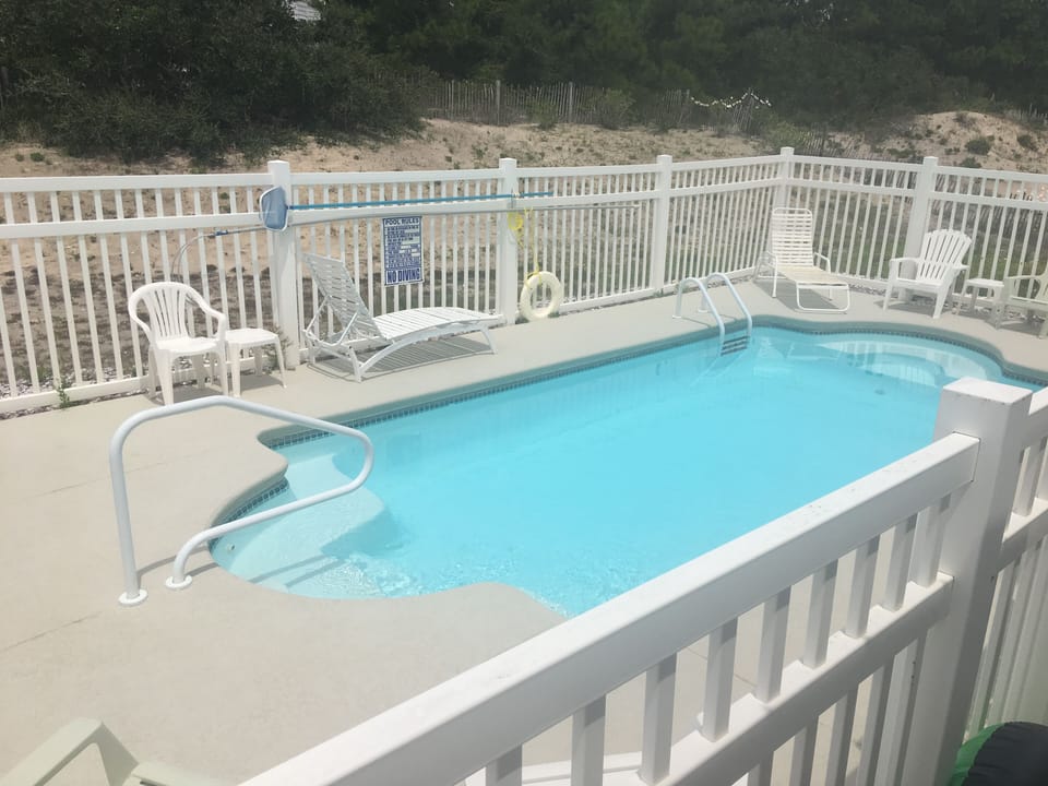Pool has 3 lounge chairs, & table w/4 straight chairs. No umbrella.