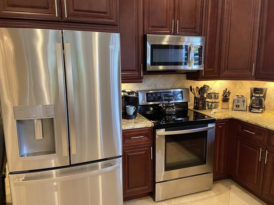 Top of the line refrigerator, stove, microwave. Keureg, coffee maker, tea pot.