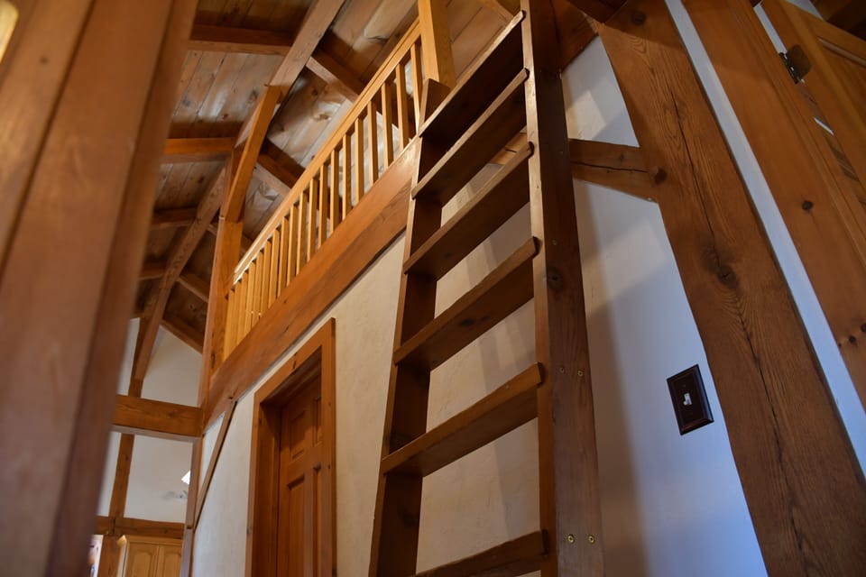 loft stairs to area with two twin beds
