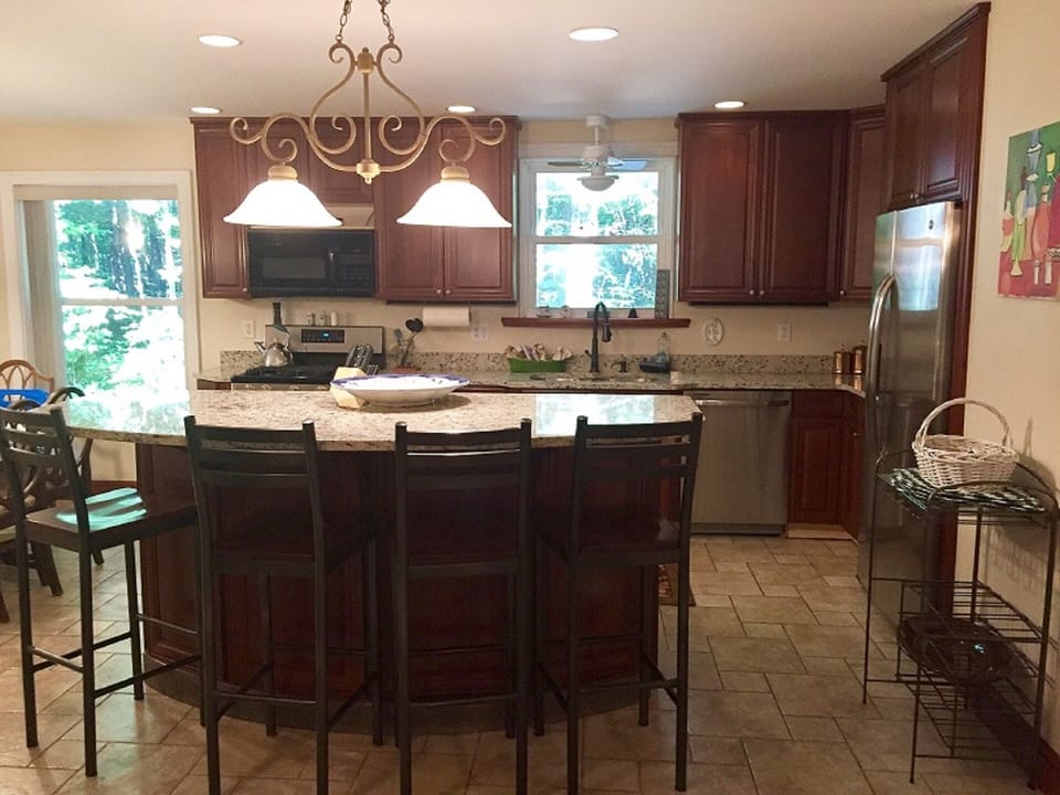Island with granite counter top. Sits 4.