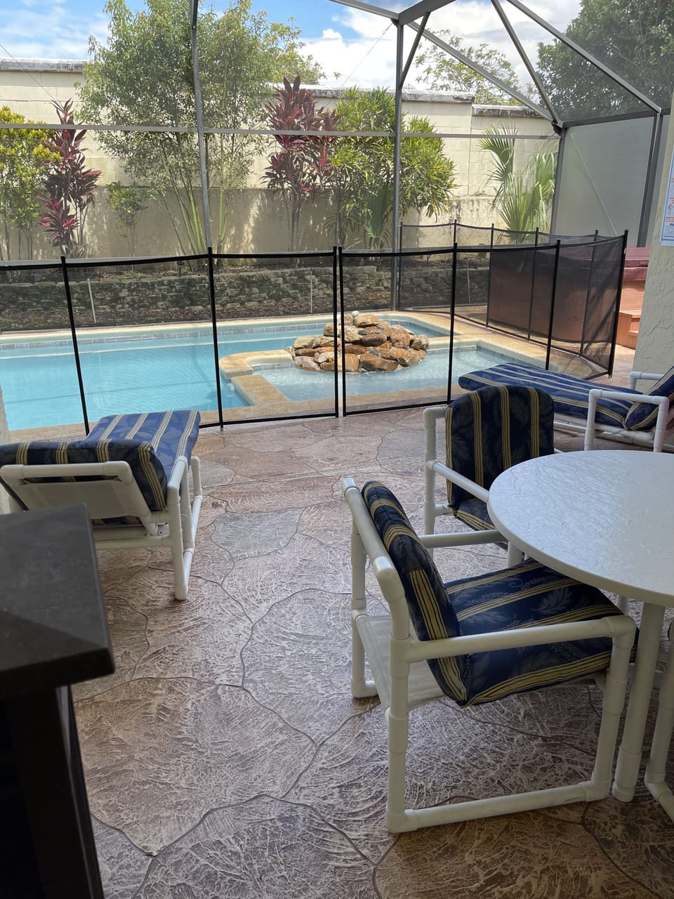 Safety pool fence surrounding pool.