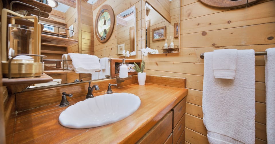Upper unit bathroom with single vanity