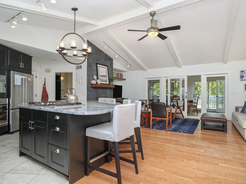 Open living area with kitchen and living room with fireplace.