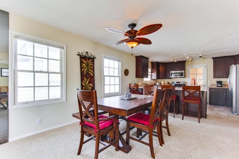 Dining seating for 6 with ceiling fan and overhead lighting above table