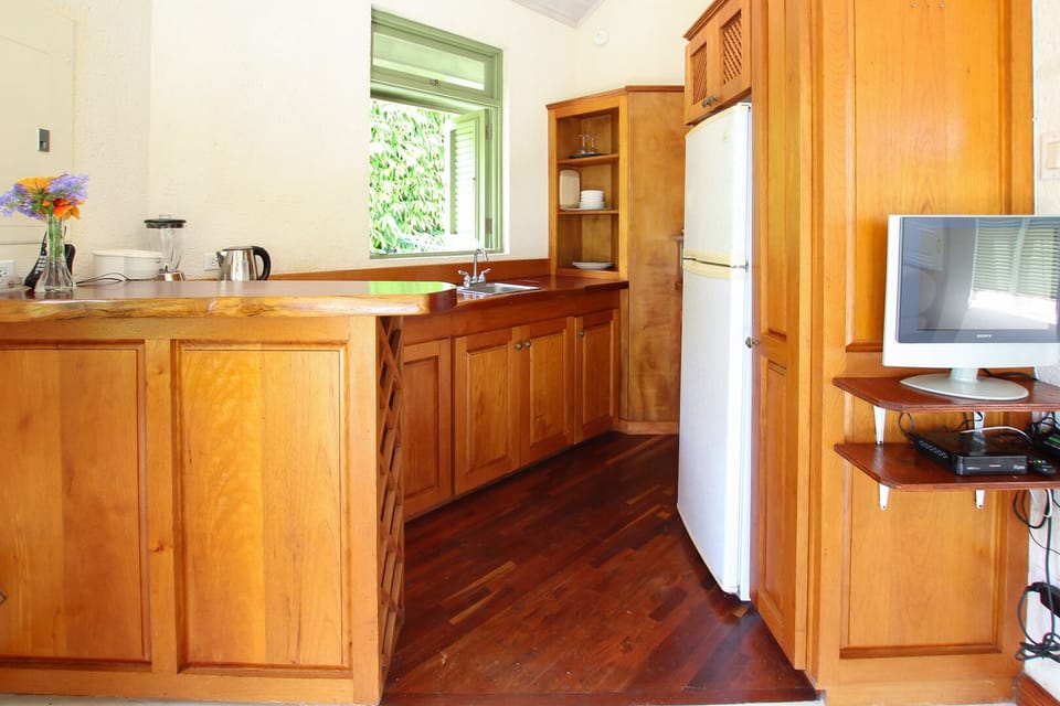 The kitchen space has a full size fridge/freezer, 2-burner stove, kettle, coffee maker, blender, toaster and kitchen utensils