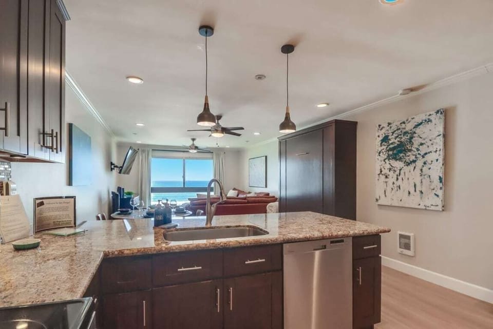 Views of the ocean while cooking! Stainless steel appliances include a dishwasher, refrigerator/freezer, oven and microwave
