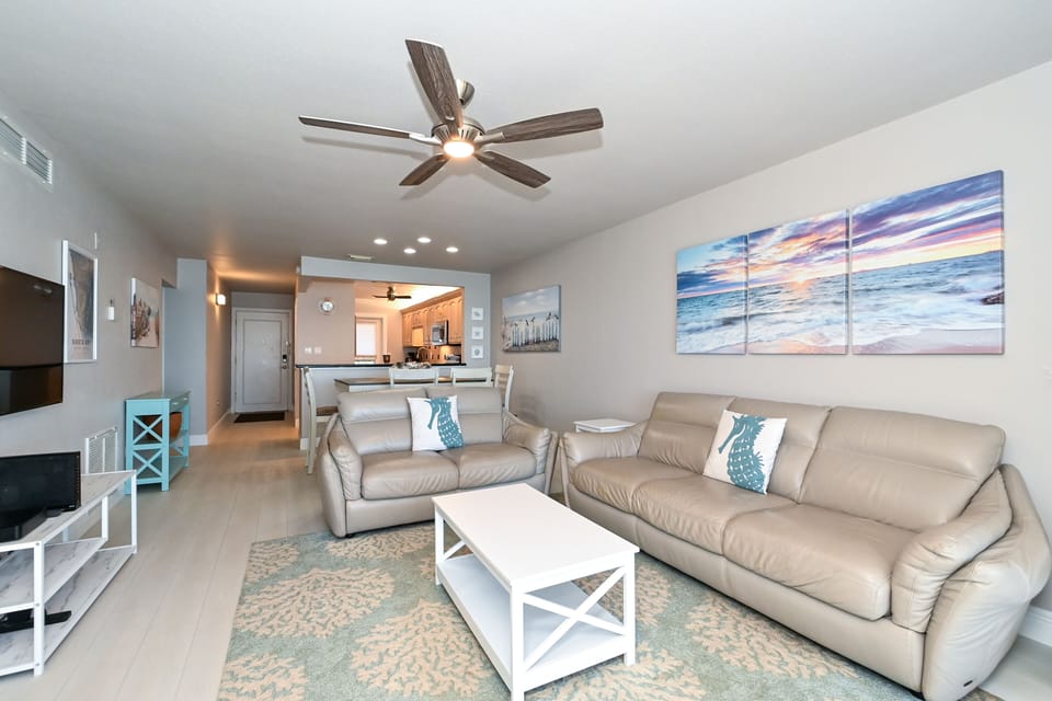 Spacious living room with view out to Lanai, the beach and azure waters of the Gulf of Mexico...large HDTV, stereo, and more...