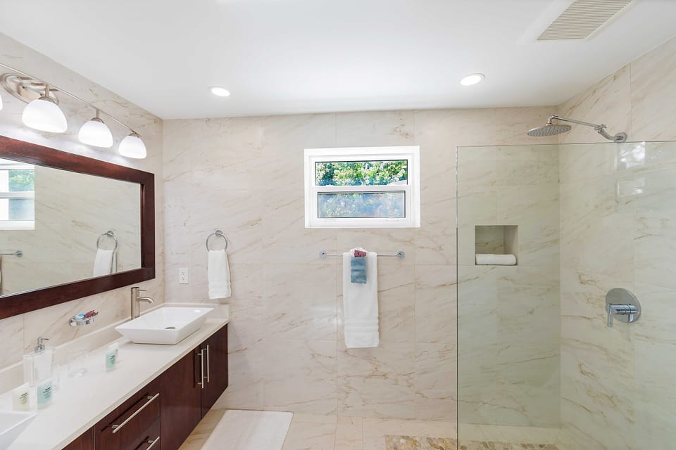 Indulge in unparalleled luxury within our exquisite en suite bathroom, boasting a generously sized walk-in shower that enhances your bathing experience