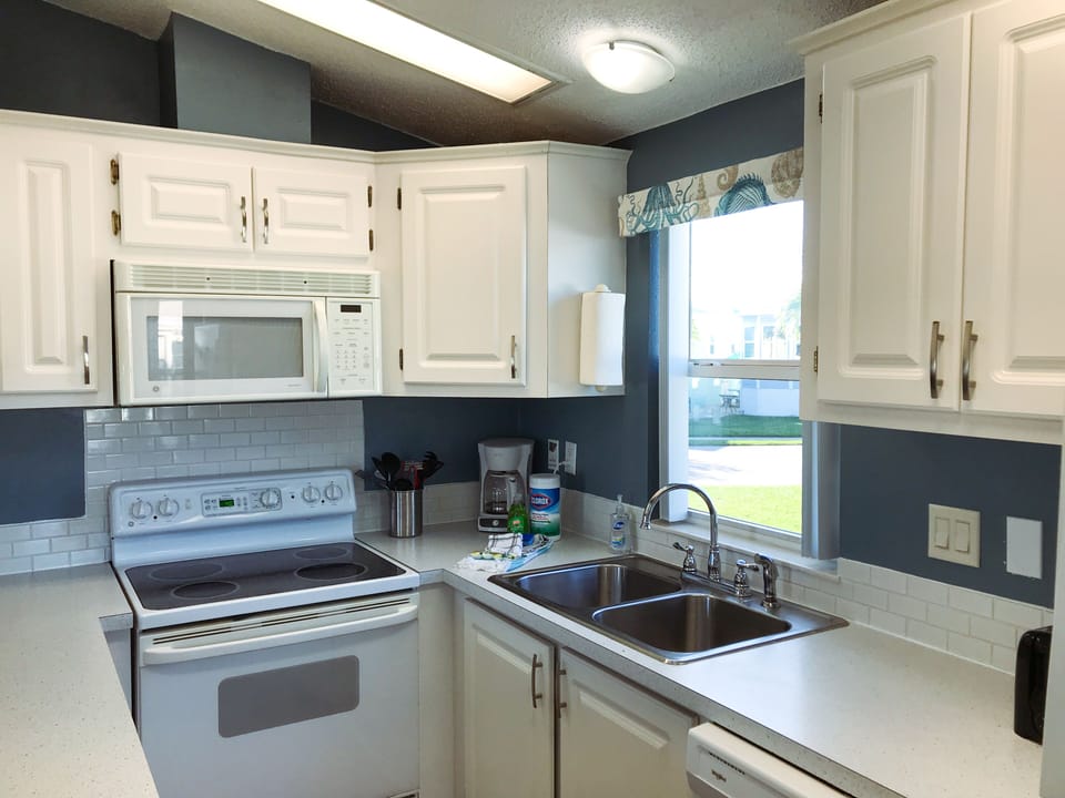 A kitchen with all the essentials that you will need for dishes and utensils