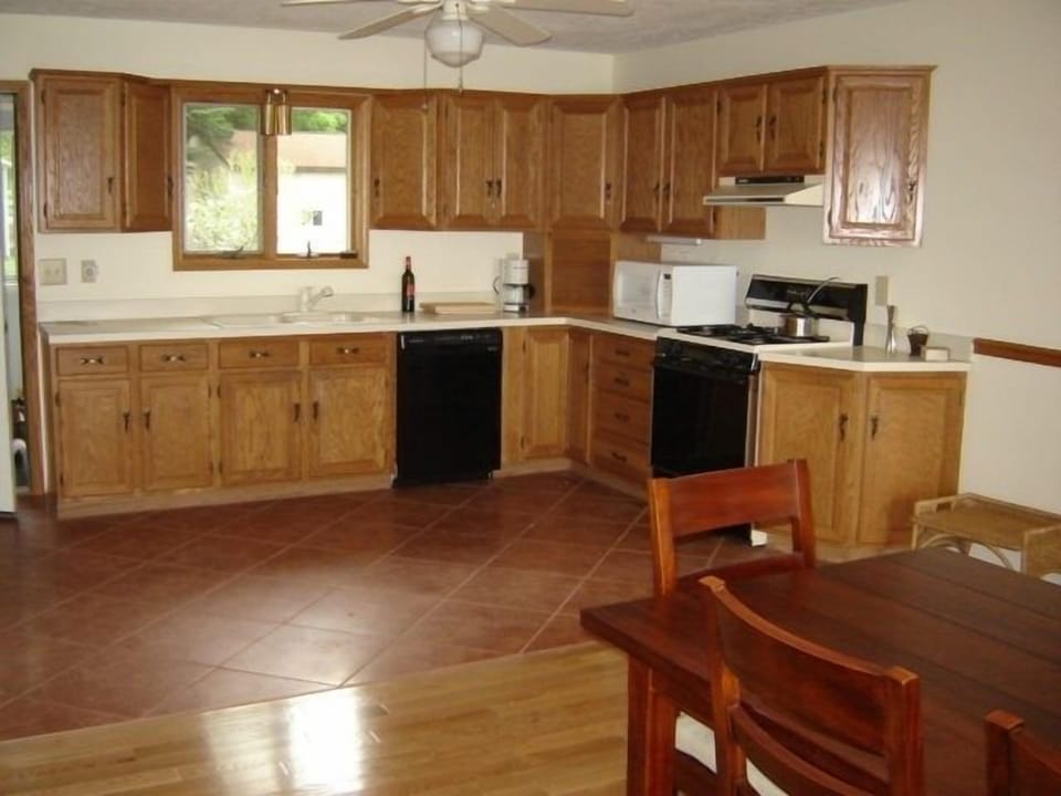 spacious kitchen is stocked for serious cooking! great flower garden view.