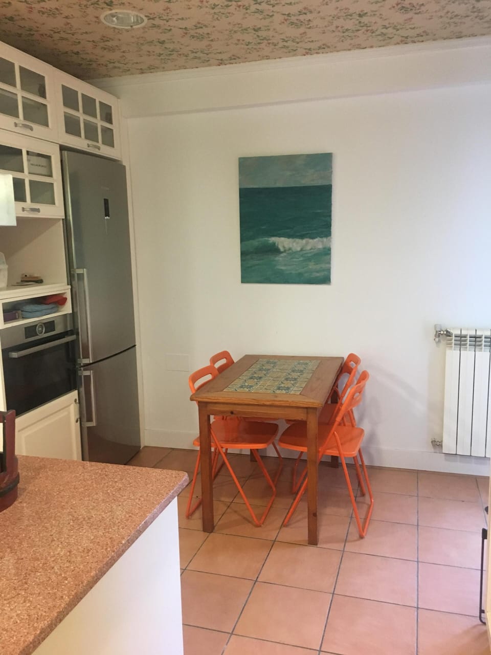 Kitchen with table, oven and access to the terrace.