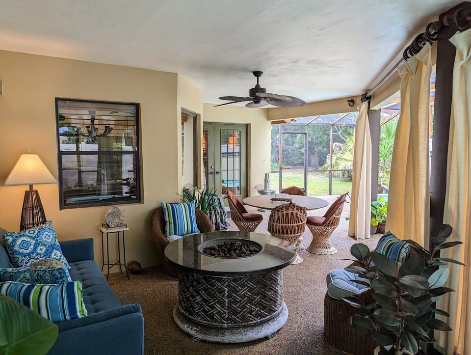 Screened Outdoor Living Area with Lounge and Dining Seating, Spa, BBQ, Pond