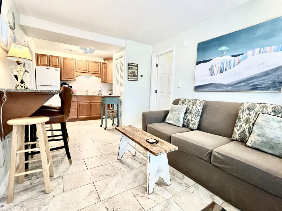 Enter in to this bright and beachy slice of heaven!  With a queen sofa, counter seating, and full kitchen.  Both bedrooms are located off of this common area.