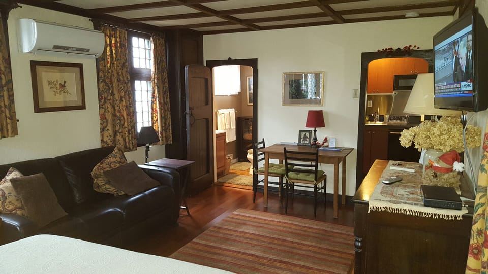 Inside Herringbone Cottage. Living-room area with galley kitchen.