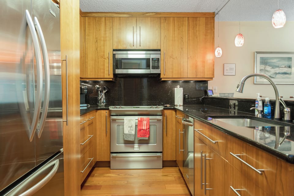 Fully stocked kitchen with granite counter tops and stainless steel appliances. 